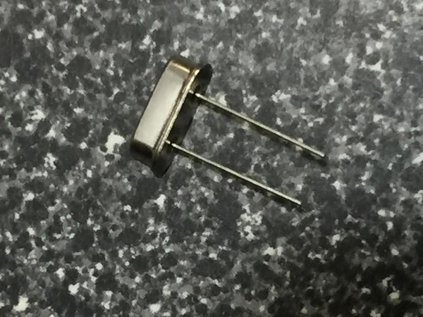 24 MHz HC-49/S quartz crystal, side view, bright metal can, two straight leads