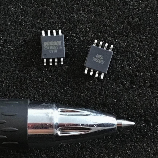 Winbond 25X16BVSIG eight-pin SOIC flash chip and second marked chip beside pen tip