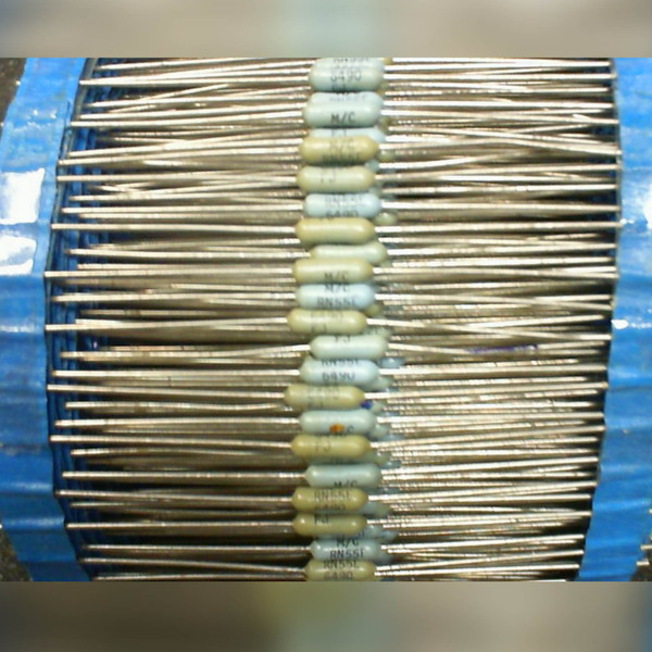 Axial lead resistors on ammo-belt tape, bodies mix tan and pale gray with visible age discoloration. Markings include RN55E, 6490, M/C, and F J legible on multiple bodies.