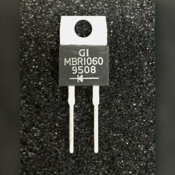 GI MBR1060 Schottky rectifier, two-lead TO-220AC case with tab hole, on a dark speckled surface
