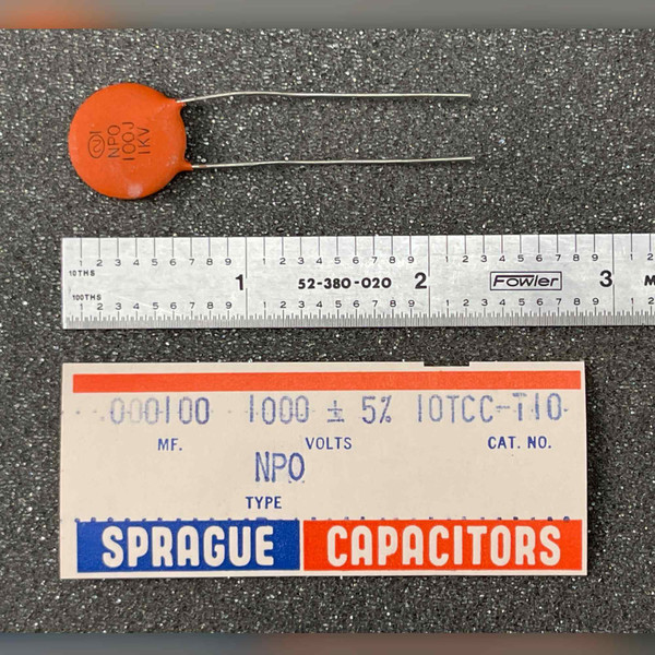 Sprague 10TCC-T10 100pF 1kV NPO ceramic disc capacitor with Fowler scale and Sprague label card