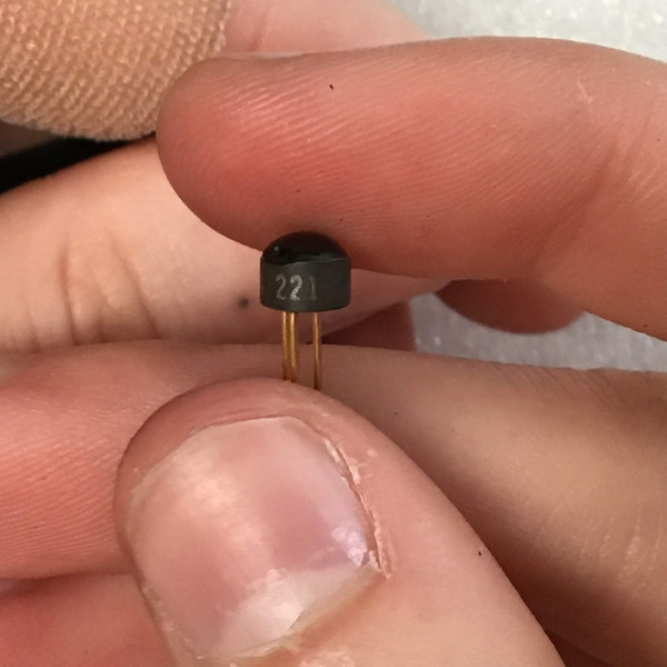 Transistor body clean, marking "221" clear, leads straight and bright showing no corrosion.