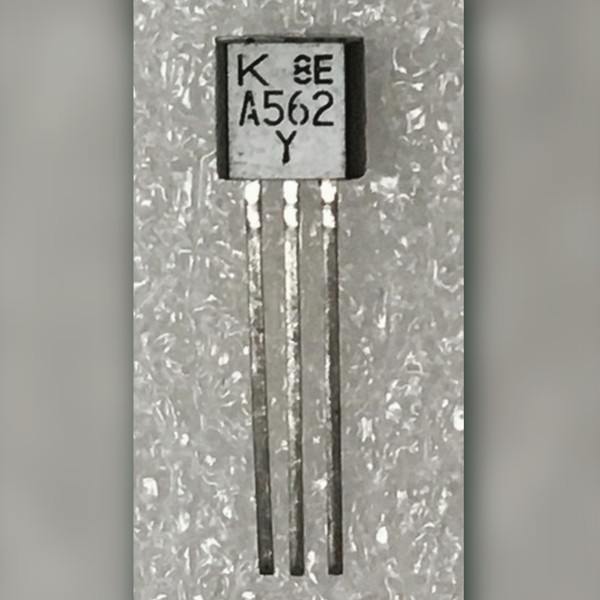 Toshiba A562 Y PNP transistor on textured plastic sheet, leads straight and untrimmed