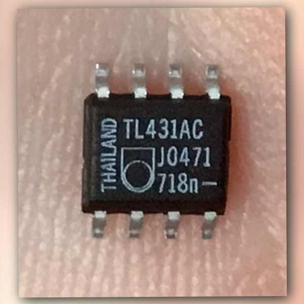 Black SO-8 chip on a light crinkled backdrop, printed TL431AC, J0471, 718n and THAILAND