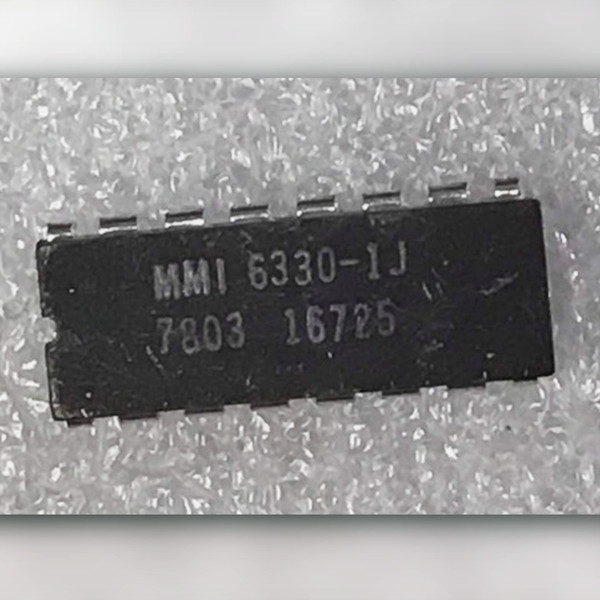 Top of black ceramic 16-pin DIP marked MMI 6330-1J with 7803