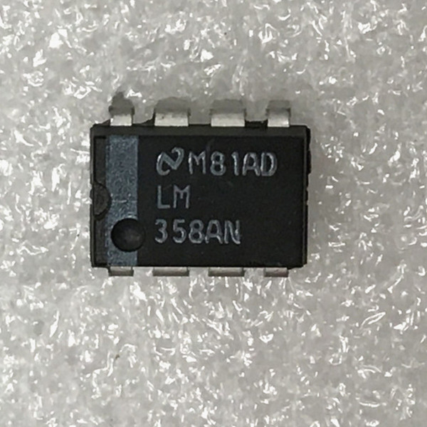 National Semiconductor LM358AN 8-pin DIP op amp top marking held in hand, leads visible