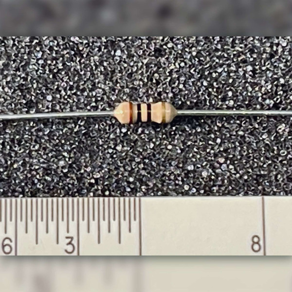 Close-up of Xicon 291-10 10 Ohm carbon film resistor showing color code bands.