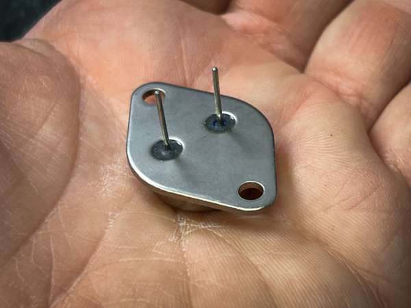 SGS 12020-E TO-3 pin side held in hand, two straight bright pins in glass seals