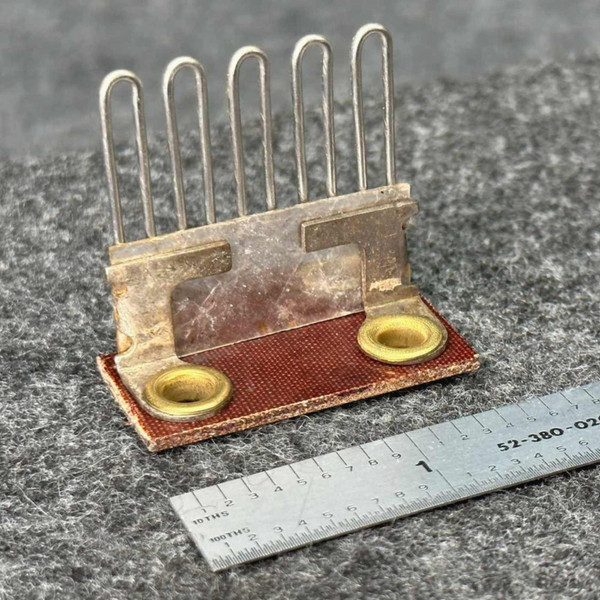 Federal Pacific F3.55 heater element at an angle, five wire loops, mica plate, brass eyelets, ruler