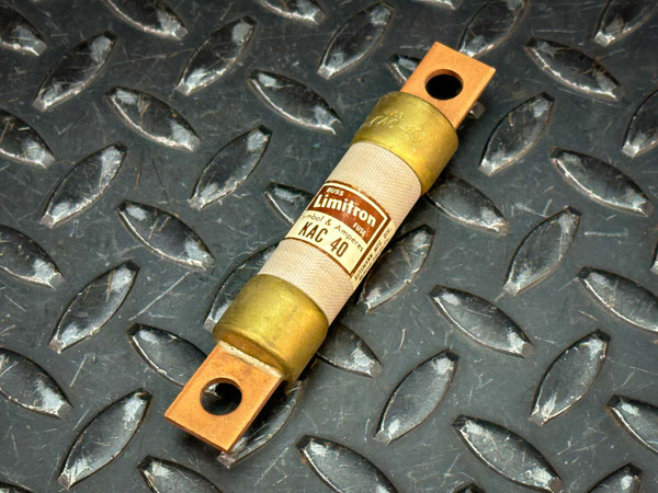 High-speed rectifier fuse, model KAC 40, featuring a beige fiber cartridge body, brass end caps, and copper blade terminals with mounting holes, shown resting on a diamond plate metal surface.
