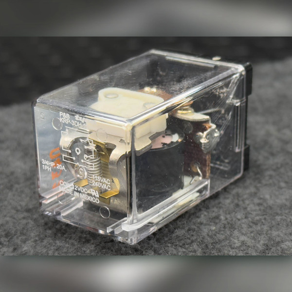 KRP-3DH-12 relay angled view showing clear case, coil, contacts and case markings