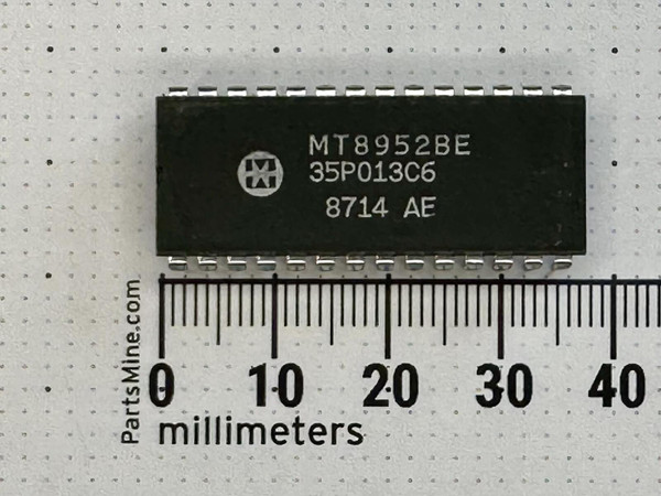 Mitel MT8952BE 28-pin plastic DIP marked 35P013C6 8714 AE, top view beside millimeter ruler