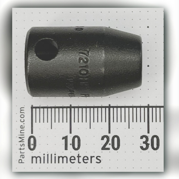 Dark Proto impact socket beside millimeter ruler, 7210HF struck into the body