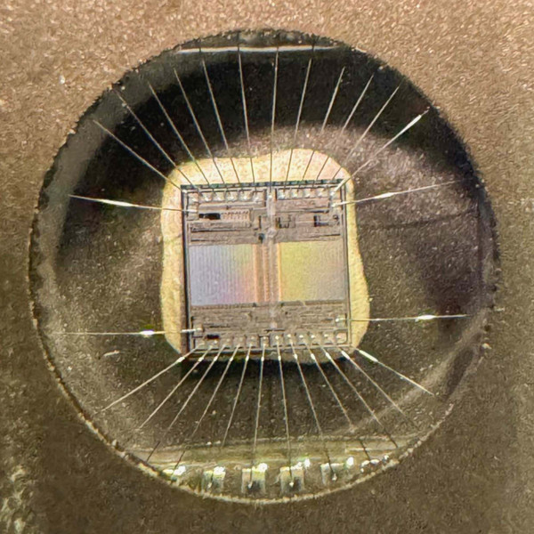 Macro through quartz window showing AM27C128 silicon die and fine bond wires