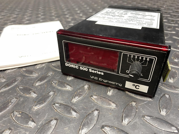 Doric 500 Series indicator angled front view with operator manual and rear label