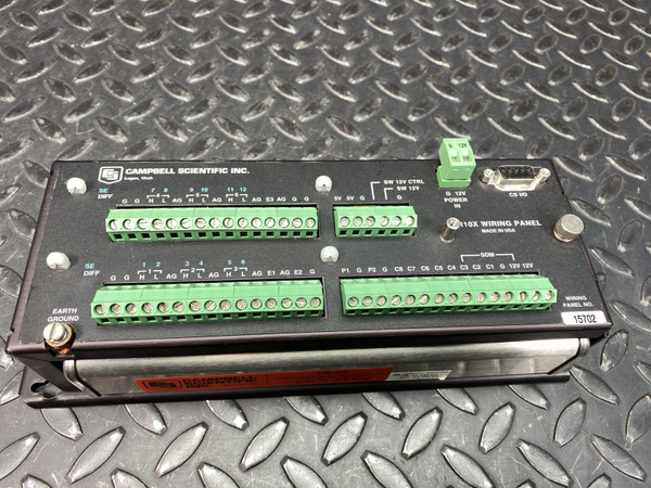 Campbell Scientific CR10X data logger shown with its detachable black wiring panel featuring four rows of green terminal blocks, a 9-pin serial (DB9) connector, and a removable green power terminal block.