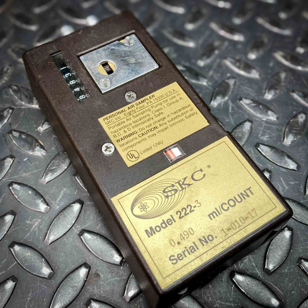 SKC 222-3 personal air sampler, angled top view showing stroke counter and gold nameplates