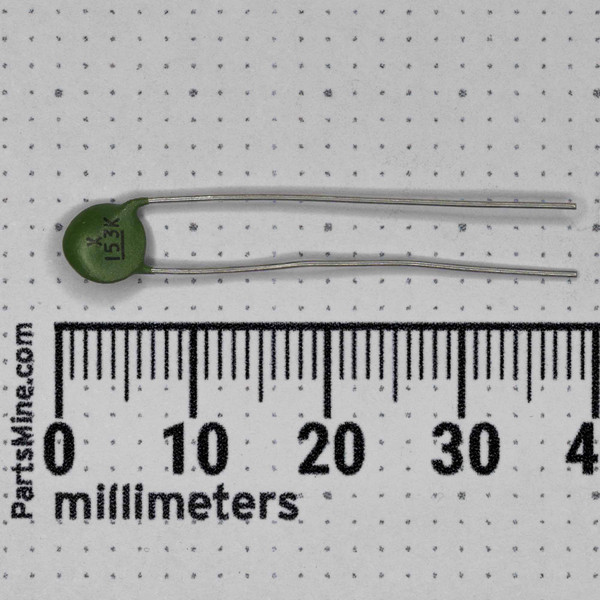 Green ceramic capacitor marked X 153K, showing clean body and leads, no visible damage or corrosion.