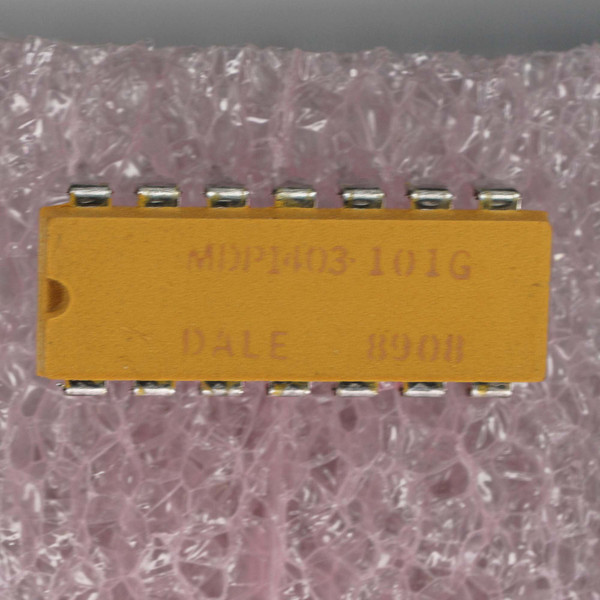 MDP1403-101G DALE 8908 visible on orange DIP package. Leads clean, straight, no corrosion. Pin 1 dot visible.
