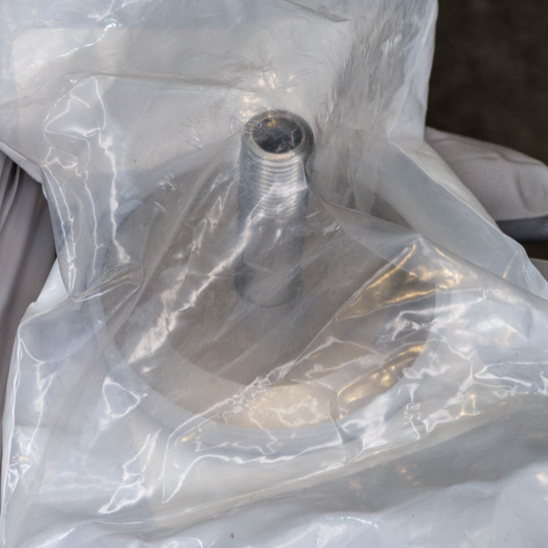 KF40 adapter in clear plastic bag showing clean 1/8 MNPT threads and smooth flange surface, no visible corrosion or damage.