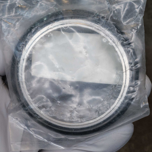 KF50 centering ring in sealed plastic bag, stainless ring showing no visible scratches, Buna-N O-ring appears new.