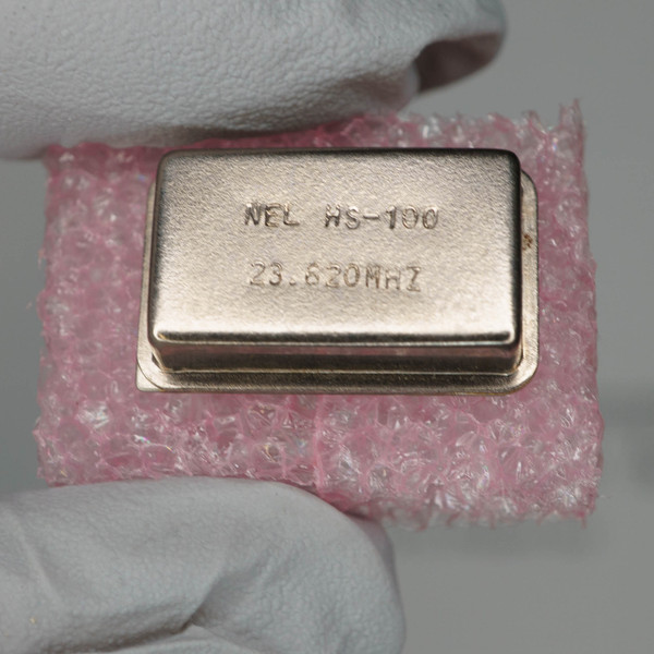 NEL HS-100 23.620MHZ stamped on clean metal can, no visible corrosion or wear.
