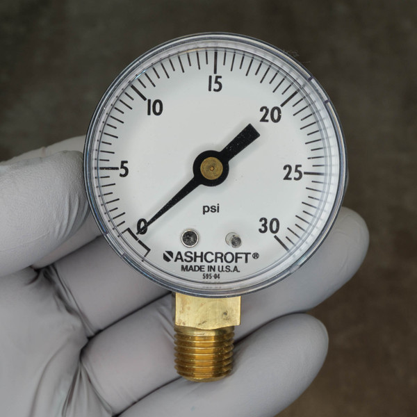 Ashcroft pressure gauge 0-30 psi range clear dial face needle at zero clean brass threads.