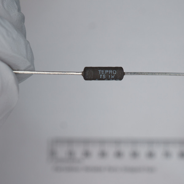 Black axial-leaded body marked TEPRO, TS 1W, and partial code readable as 5 0.05%. Straight tinned leads, no visible damage.