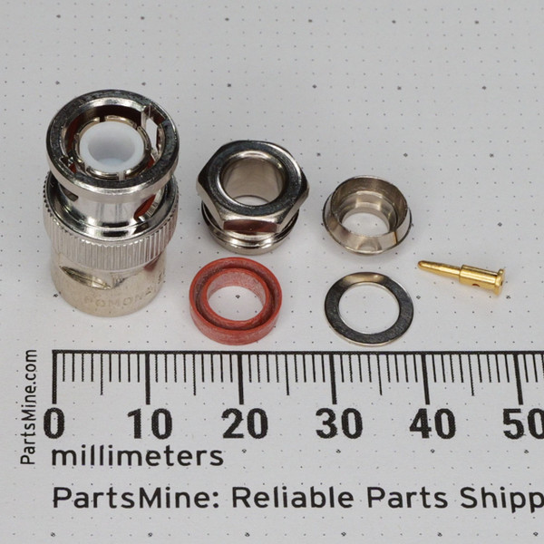 Pomona 4786 BNC male connector components laid out with ruler for scale.