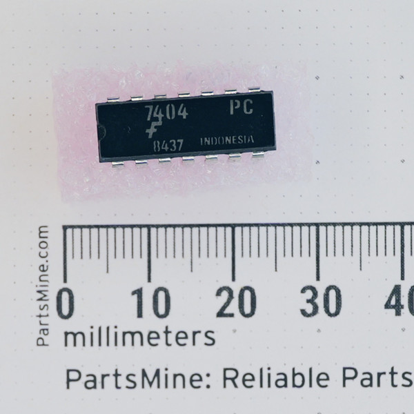 Fairchild 7404PC 14-pin DIP IC shown with a millimeter ruler.