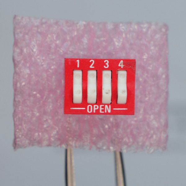 Top view of Grayhill 76SB04S 4-position DIP switch.