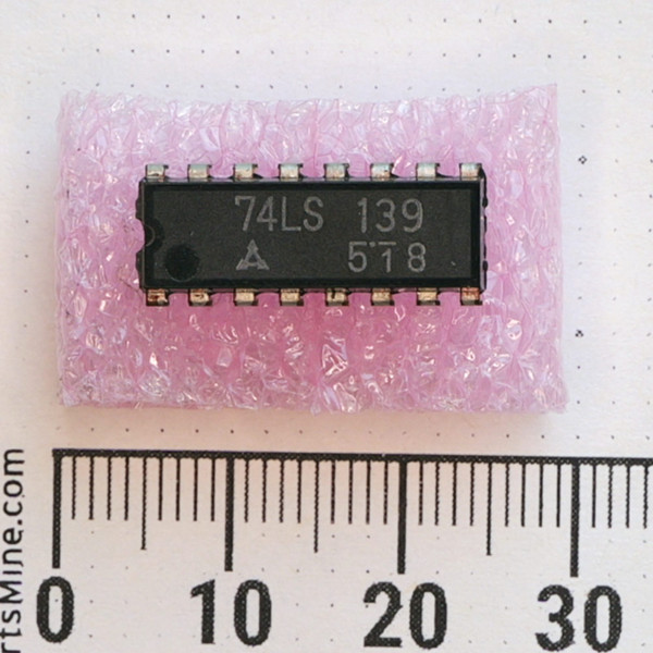 Top view of Mitsubishi 74LS139 16-pin DIP integrated circuit on pink foam.