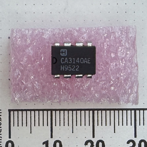 Top view of Harris CA3140AE DIP-8 IC on pink foam.