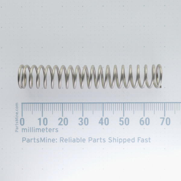 Century Spring W-40CS compression spring shown next to a millimeter scale ruler.