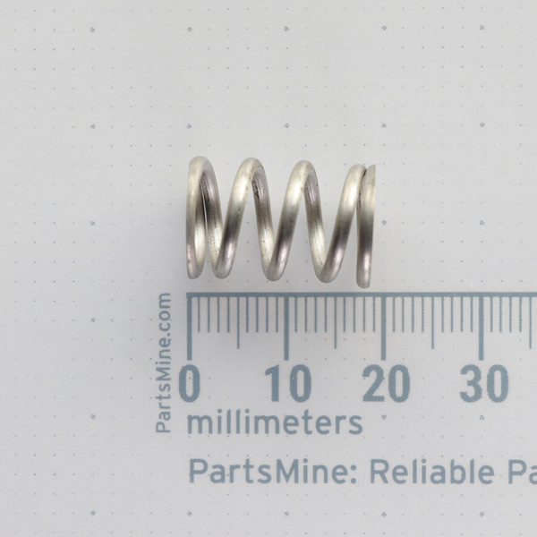 Side view of Century Spring S-1401 CS compression spring on a millimeter grid.