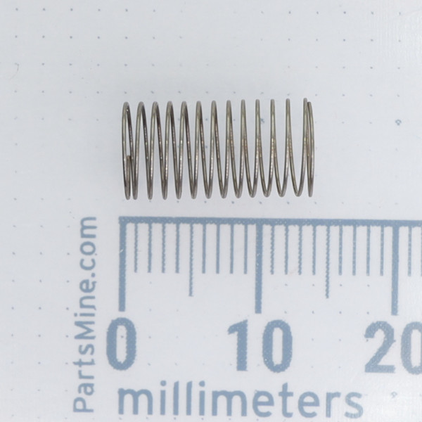 Century Spring W87-CS compression spring shown next to a metric scale.