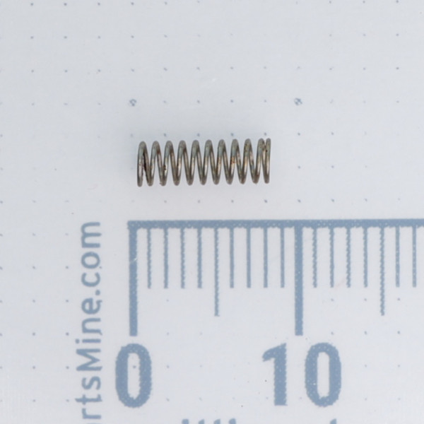 Century Spring G16-CS miniature coil spring next to a metric ruler.