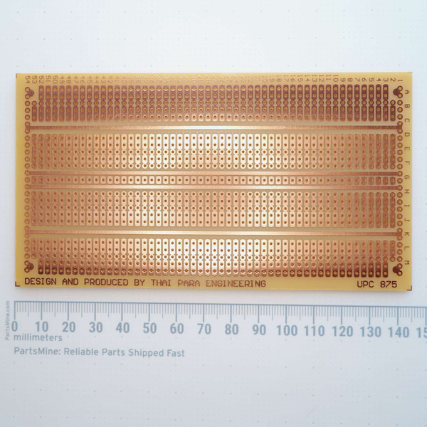 Copper trace side of Thai Para A-5462 prototyping board with millimeter ruler.