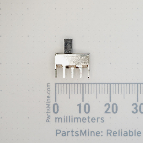 PARTSMINE A-659 slide switch next to millimeter ruler.