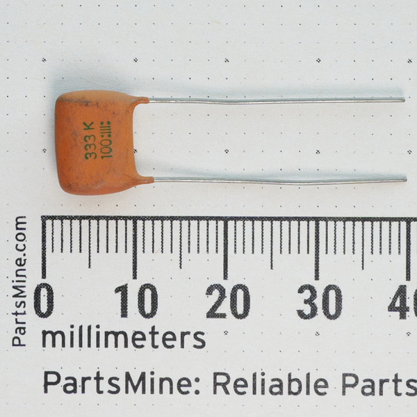 ECQ-M1333KZ film capacitor marked 333 K 100V shown with millimeter scale.