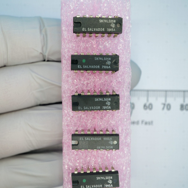 Five Texas Instruments SN74LS05N DIP ICs mounted in pink antistatic foam.