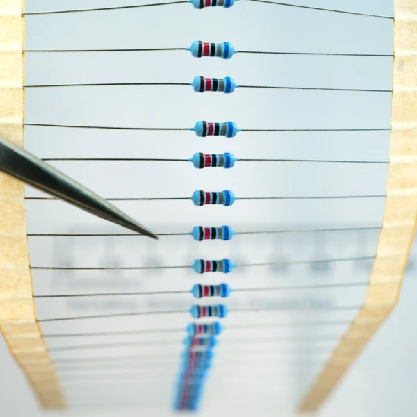 Band of axial through-hole 68k ohm resistors mounted on paper tape.