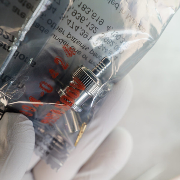 Close-up of Amphenol 000-36775 connector body, ferrule, and contact pin inside bag.