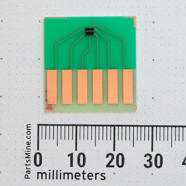Top view of Nisshinbo NJL9101R sensor mounted to carrier board with metric scale.