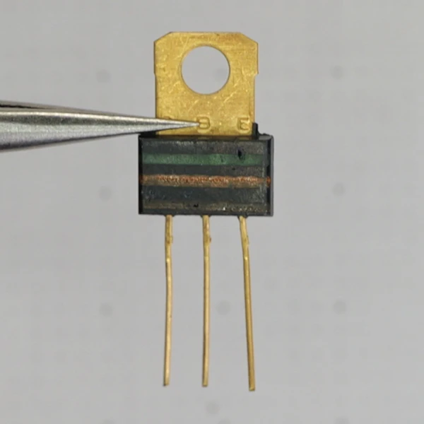 Rear view of Motorola MPSU10 transistor showing gold mounting tab and gold-plated leads.
