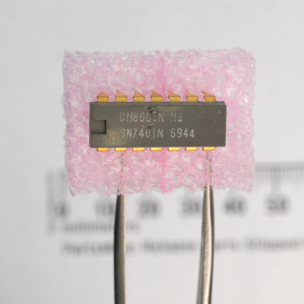 Top view of National Semiconductor DM8001N SN7401N integrated circuit in a 14-pin DIP package.