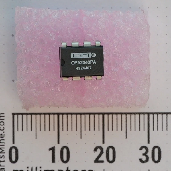 Top view of Burr-Brown OPA2340PA operational amplifier in 8-pin DIP package on pink foam.