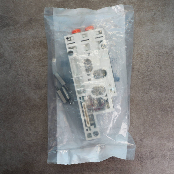 Unused SMC SY50M-2-1SA-N7 manifold base inside sealed plastic packaging.