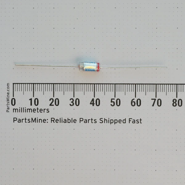 Mial 6362 axial capacitor shown next to a millimeter ruler.