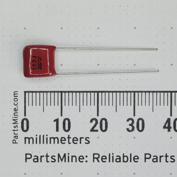 Digi-Key ECQ-B2123JF radial film capacitor beside a millimeter ruler.